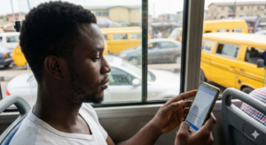 Young Nigerian filling out an online survey attentively.