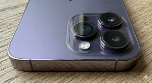 Phone 14 Pro displayed as premium app testing device.